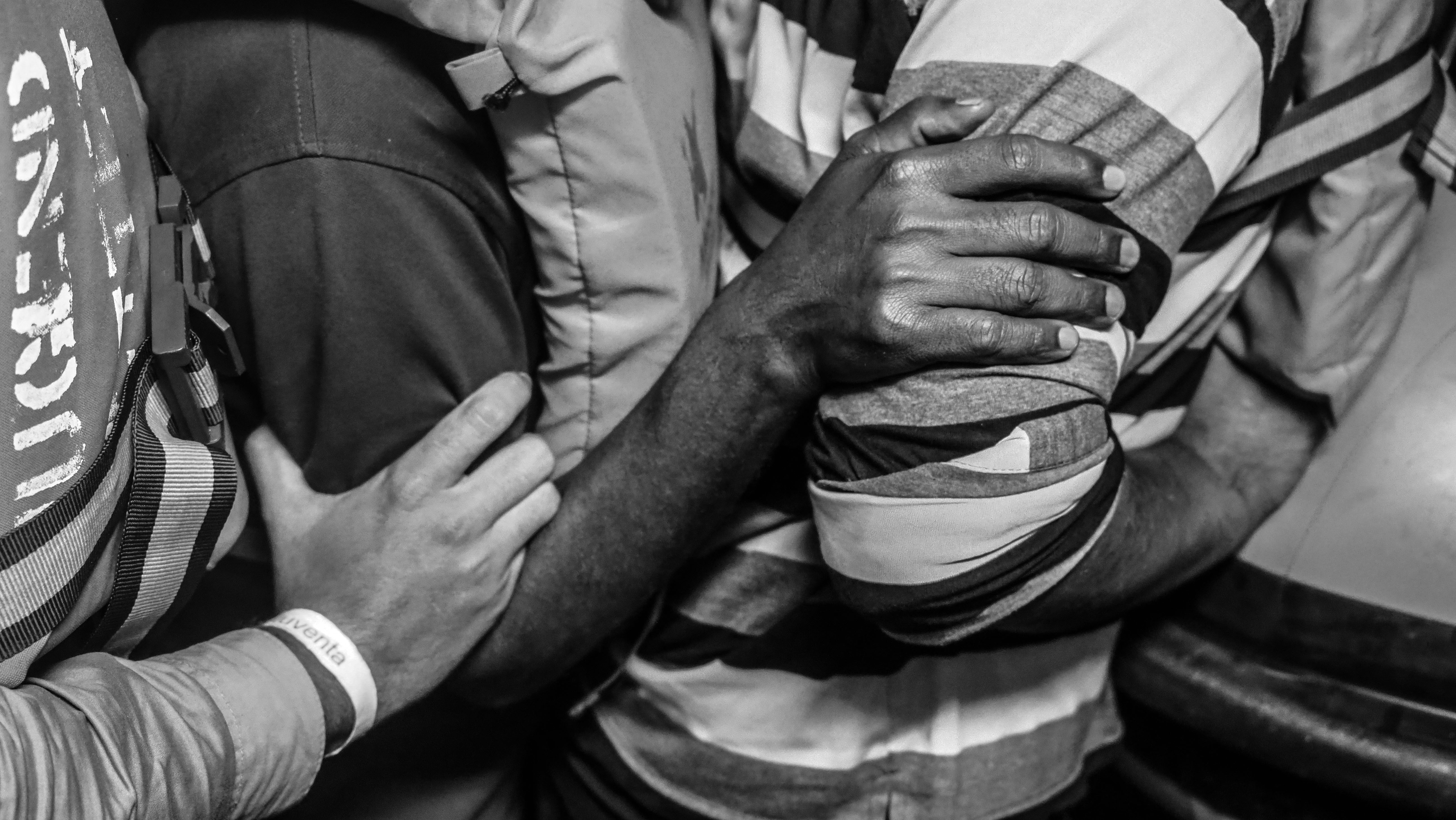 Rescued people standing close together in a row.